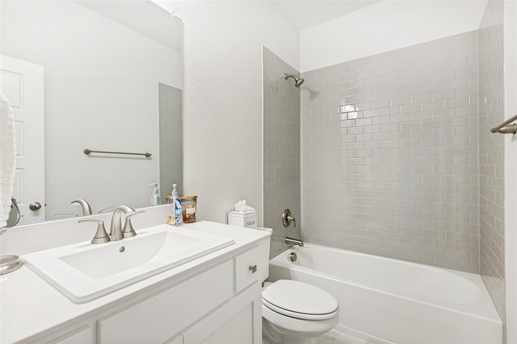 1508 Bear Path Way Gunter, TX 75058 - Photo 17 of 25 a bathroom with a sink toilet vanity and shower