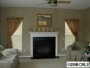 627 Eaton Court Fort Mill, SC 29708 - Photo 2 of 8 a living room with a furniture a fireplace and a flat screen tv