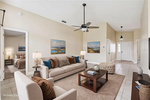 a view of a room with a chandelier fan and windows