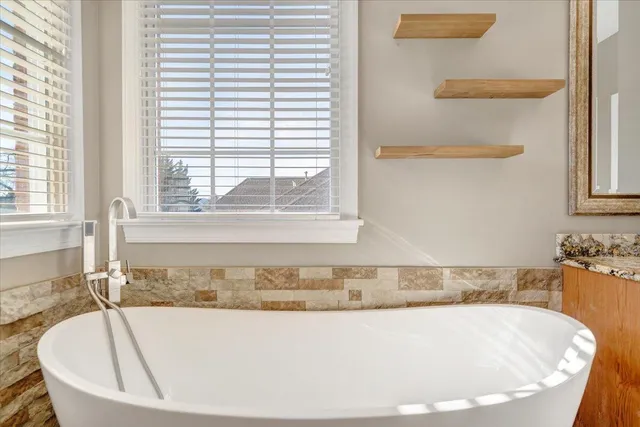 a bathroom with a granite countertop sink mirror and shower