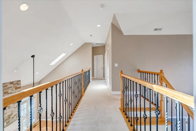 a kitchen with stainless steel appliances granite countertop a sink and a wooden floor