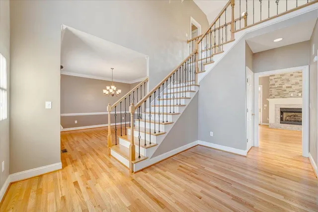 a view of a room with wooden floor and chandelier