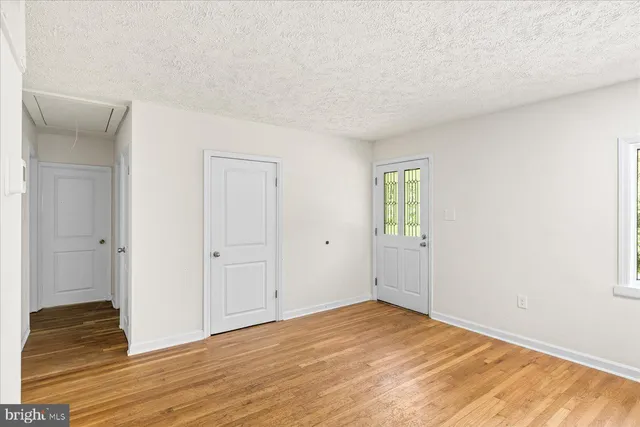 a view of an empty room and wooden floor