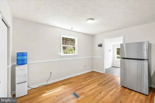 a kitchen with a refrigerator and a stove top oven