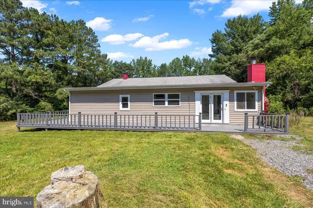 a view of a house with a swimming pool and sitting area
