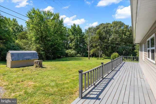 a balcony with wooden floor and outdoor seating