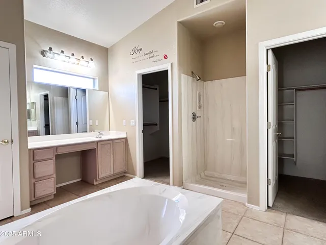 a spacious bathroom with a double vanity sink and a mirror