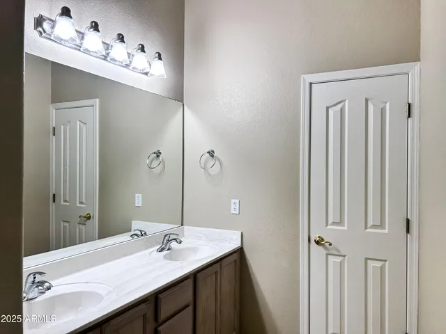 a bathroom with a sink vanity and a mirror