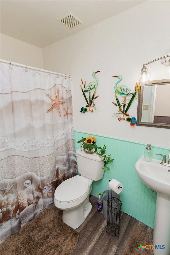 802 Bay Street Austwell, TX 77950 - Photo 14 of 27 a bathroom with a toilet sink and mirror