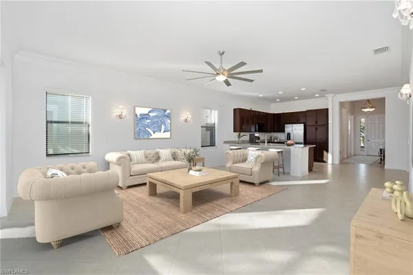 a living room with furniture kitchen view and a window