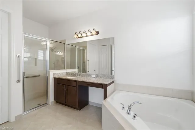 a bathroom with a bathtub sink and mirror