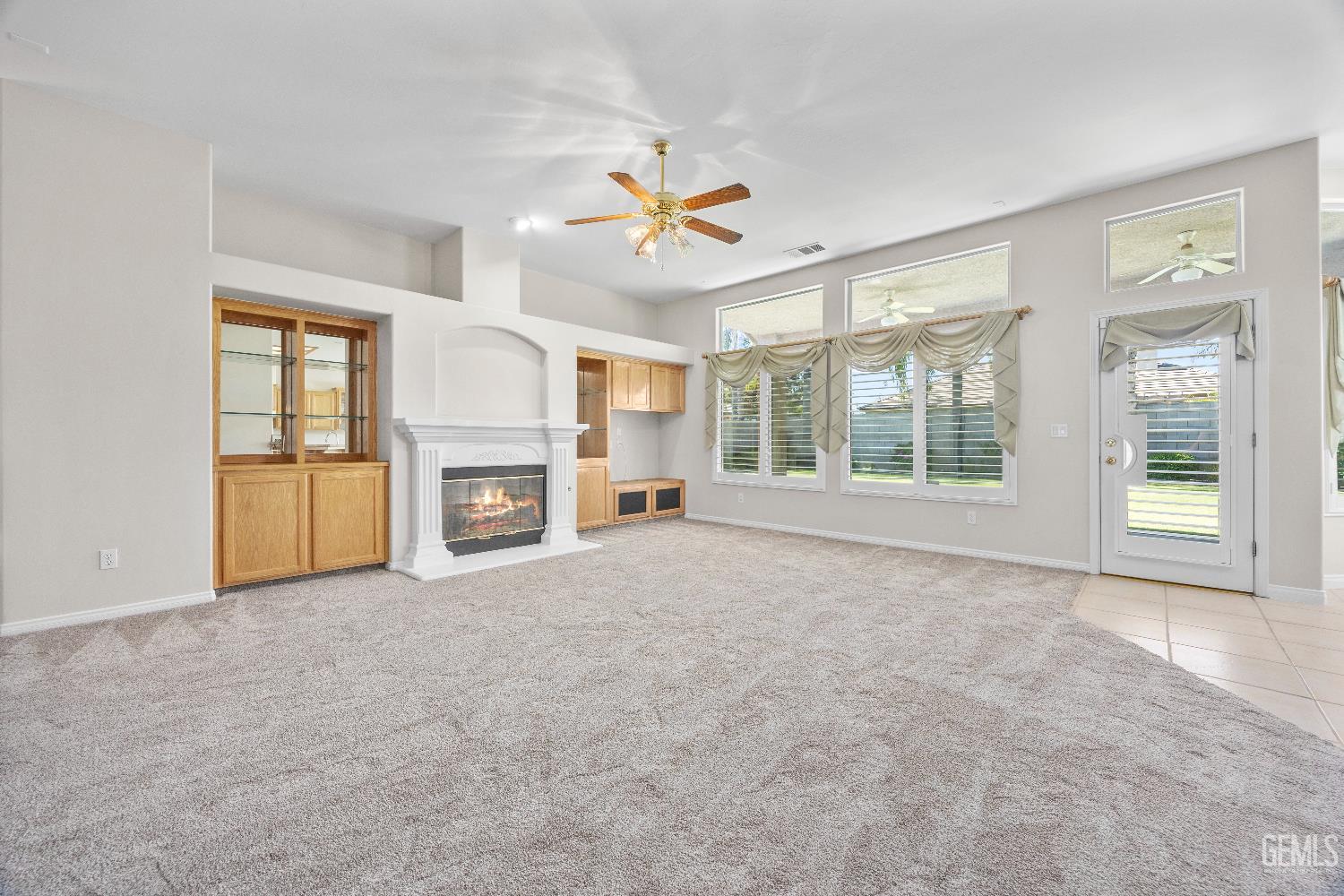 Undisclosed Address Bakersfield, CA 93312 - Photo 11 of 45 a view of an empty room with a window and a kitchen