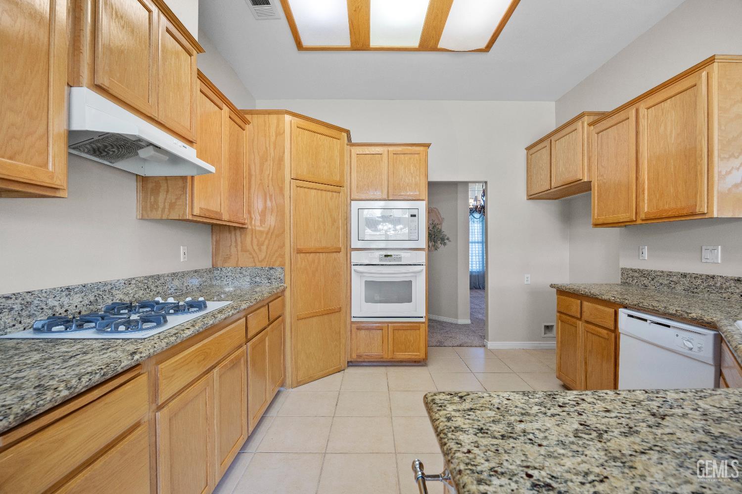 Undisclosed Address Bakersfield, CA 93312 - Photo 20 of 45 a kitchen with stainless steel appliances granite countertop a stove a sink and a microwave