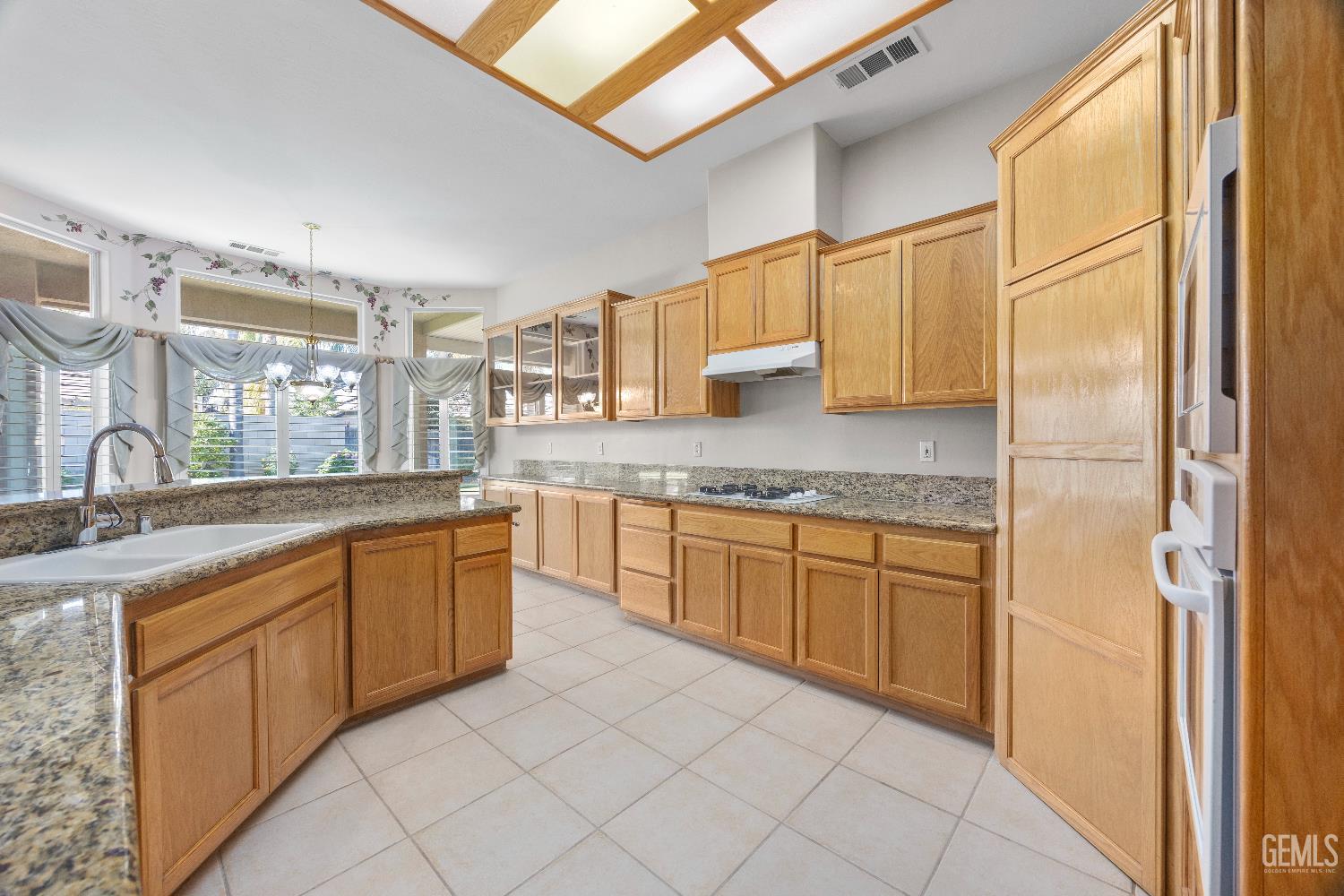 Undisclosed Address Bakersfield, CA 93312 - Photo 22 of 45 a kitchen with stainless steel appliances granite countertop a sink and cabinets