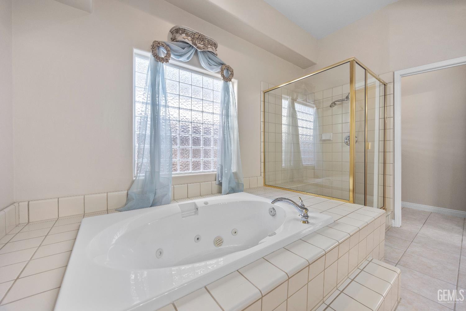 Undisclosed Address Bakersfield, CA 93312 - Photo 27 of 45 a bathroom with a bathtub and shower