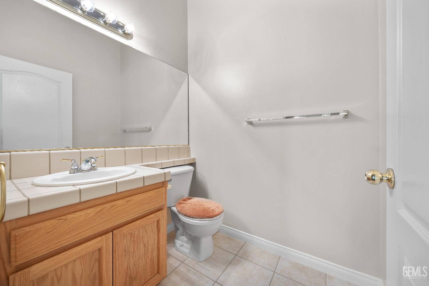 Undisclosed Address Bakersfield, CA 93312 - Photo 30 of 45 a bathroom with a granite countertop sink a toilet and a mirror