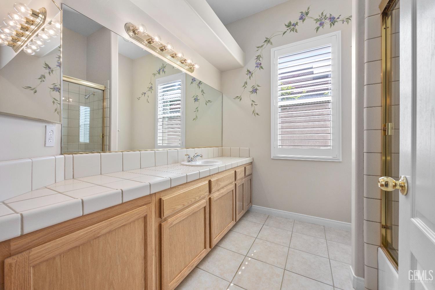 Undisclosed Address Bakersfield, CA 93312 - Photo 34 of 45 a bathroom with a granite countertop sink and a mirror