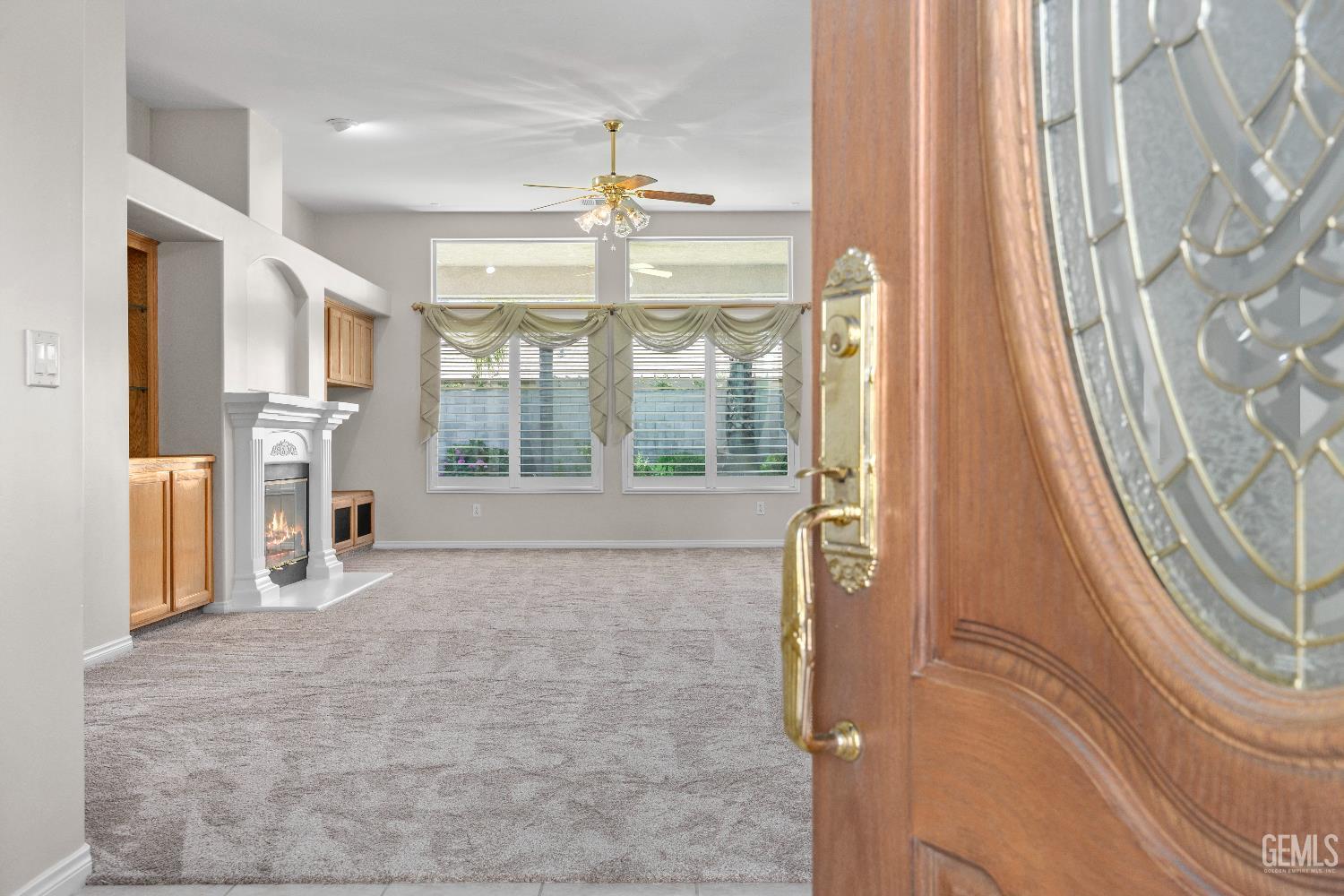 Undisclosed Address Bakersfield, CA 93312 - Photo 5 of 45 a view of an empty room with a fireplace and a window