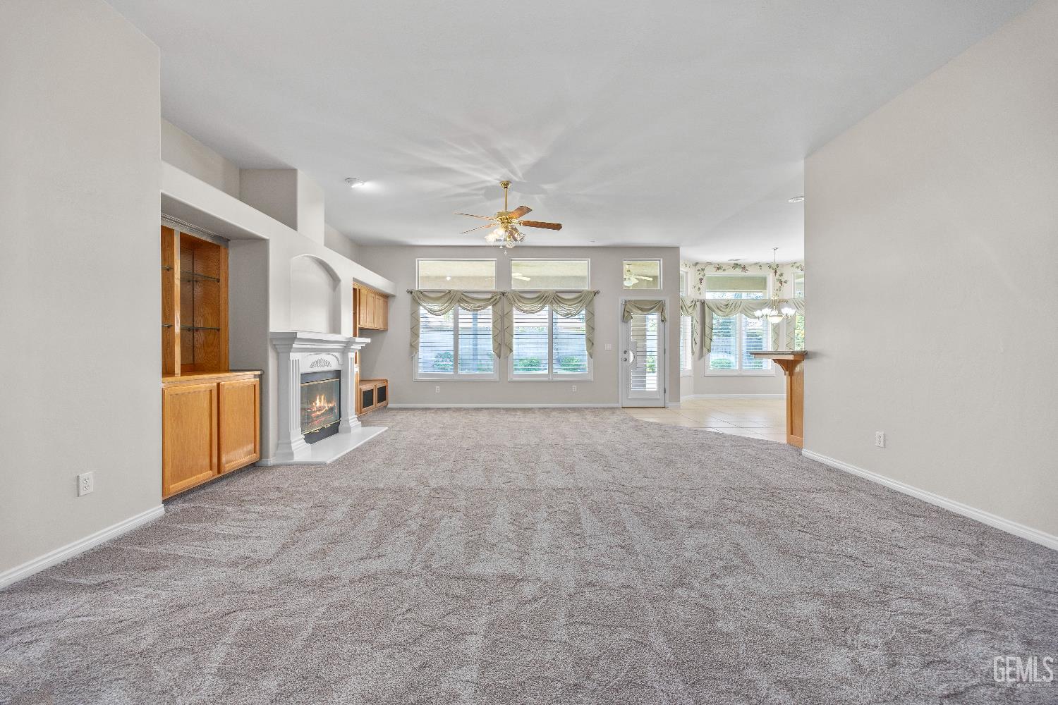 Undisclosed Address Bakersfield, CA 93312 - Photo 10 of 45 an empty room with windows and pillars in it