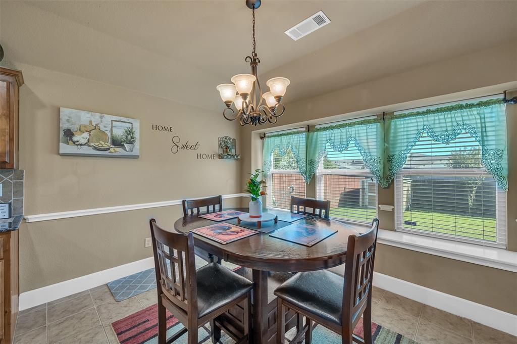 1663 Potomac Drive Burleson, TX 76028 - Photo 10 of 25 a view of a dining room with furniture window and outside view