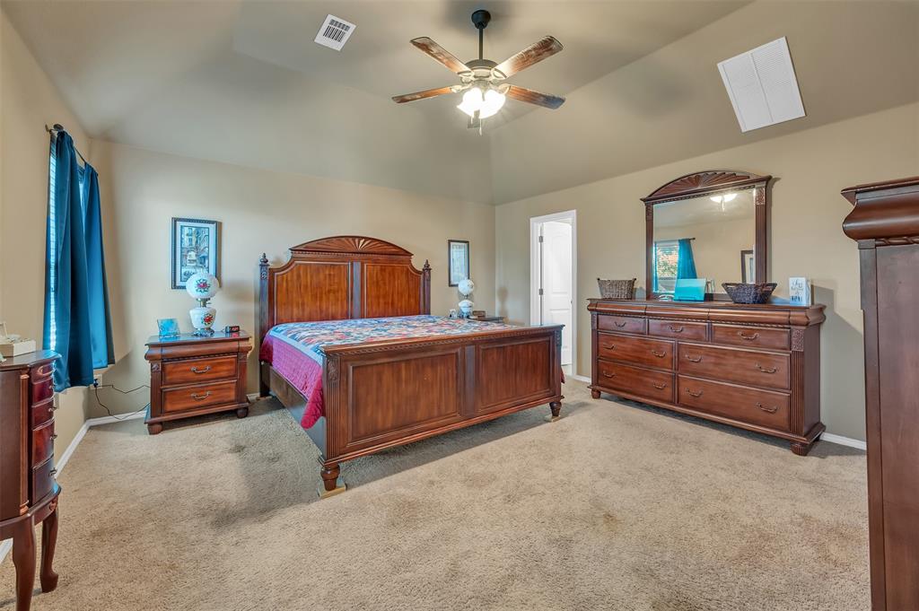 1663 Potomac Drive Burleson, TX 76028 - Photo 11 of 25 a bedroom with a bed and a chandelier