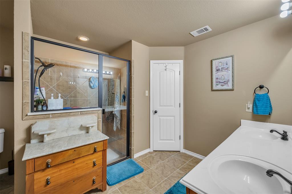 1663 Potomac Drive Burleson, TX 76028 - Photo 12 of 25 a bathroom with a sink and mirror with toilet