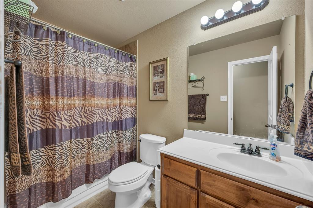 1663 Potomac Drive Burleson, TX 76028 - Photo 14 of 25 a bathroom with a sink a toilet and shower