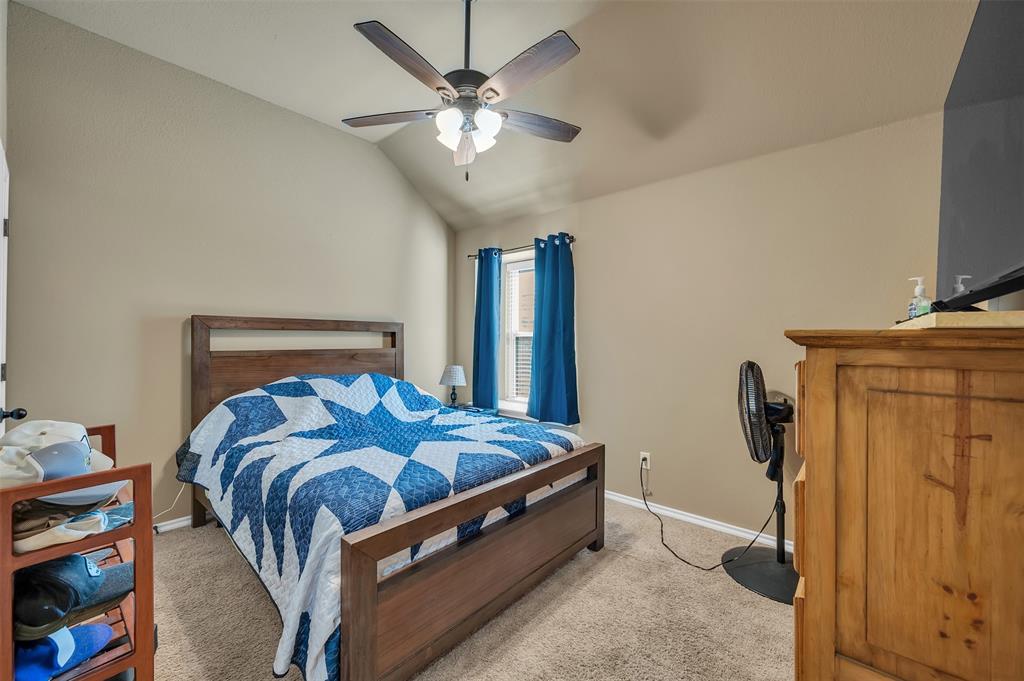 1663 Potomac Drive Burleson, TX 76028 - Photo 15 of 25 a bedroom with a bed and a chandelier