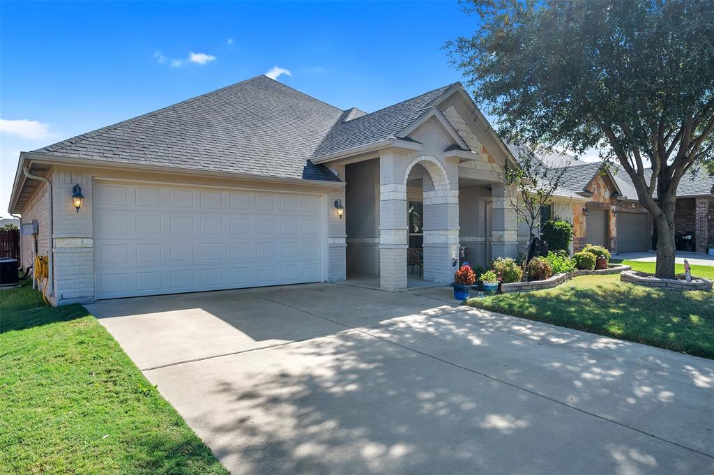 1663 Potomac Drive Burleson, TX 76028 - Photo 3 of 25 a view of a house with a yard and garage