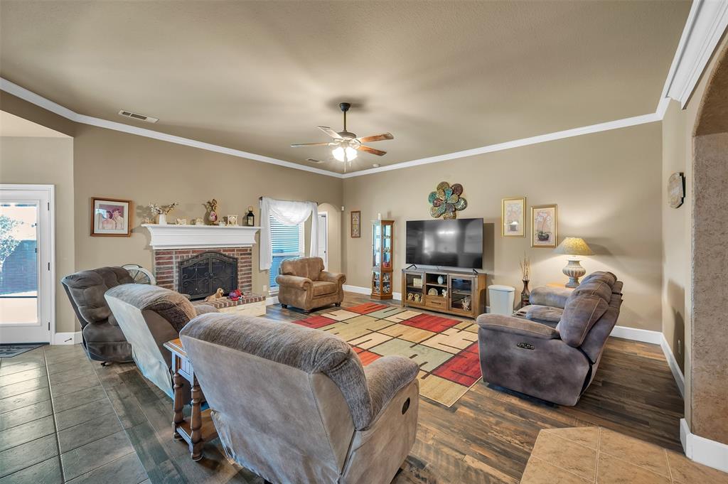 1663 Potomac Drive Burleson, TX 76028 - Photo 6 of 25 a living room with furniture a fireplace and a flat screen tv