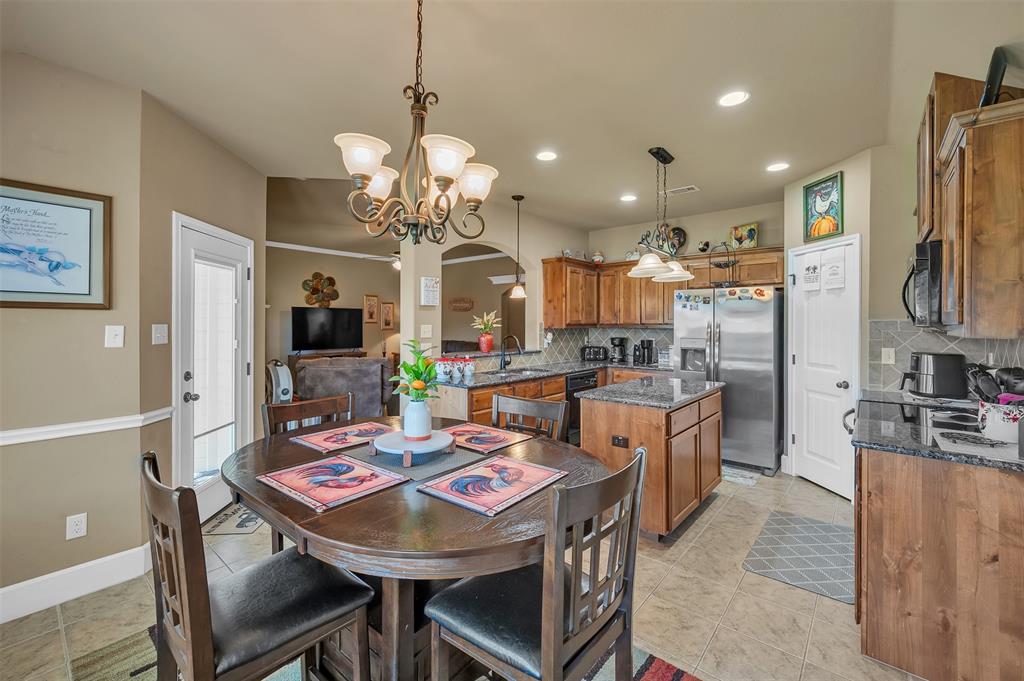 1663 Potomac Drive Burleson, TX 76028 - Photo 9 of 25 a large kitchen with a table and chairs