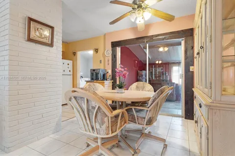 a dining room with furniture and chandelier fan