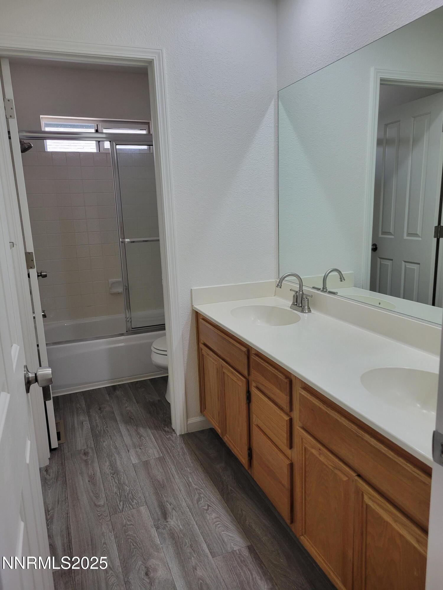2967 Aspendale Drive Reno, NV 89503 - Photo 13 of 20 a bathroom with a double vanity sink a toilet and a shower