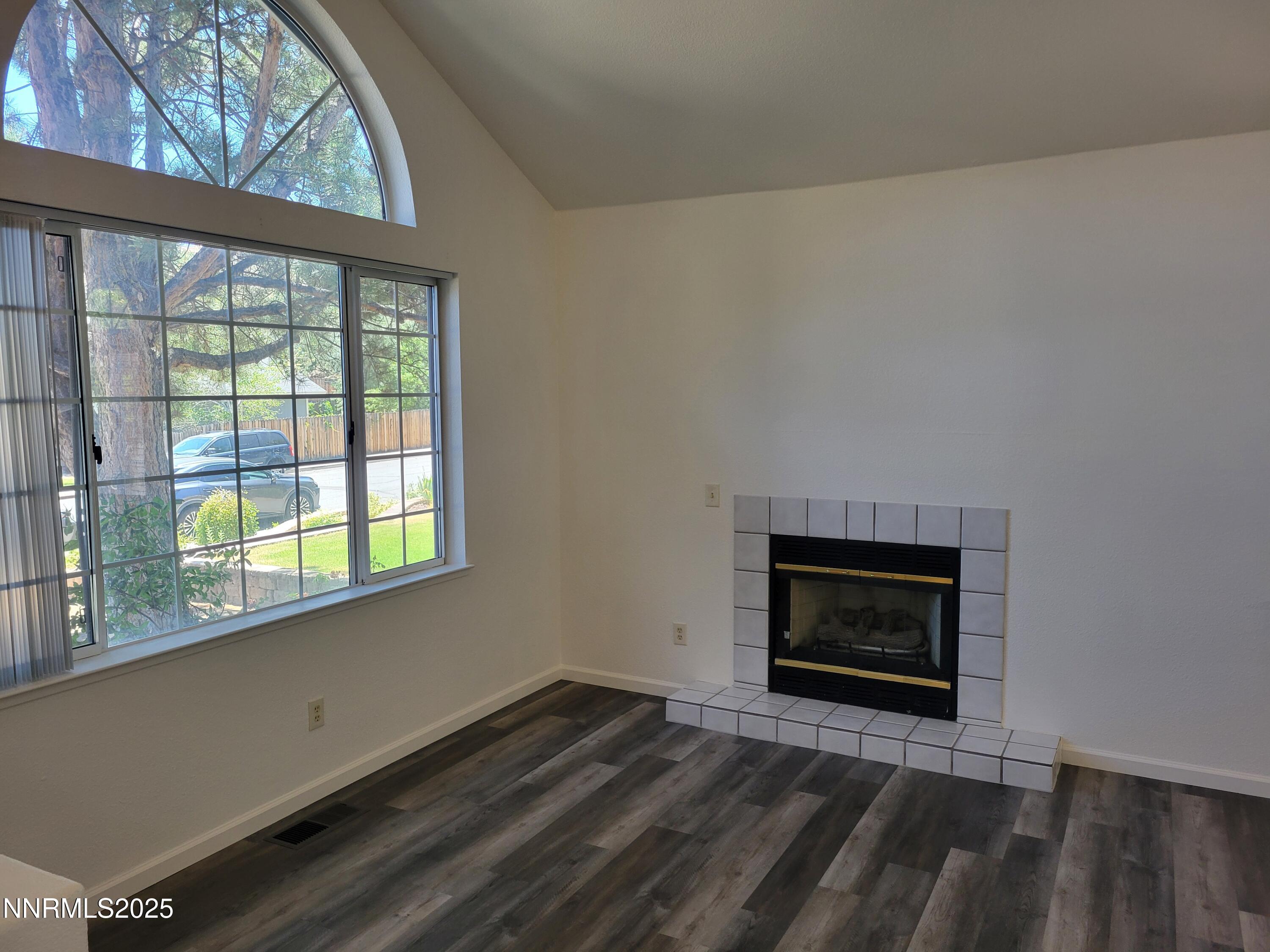 2967 Aspendale Drive Reno, NV 89503 - Photo 2 of 20 a room with a fireplace and a floor to ceiling window