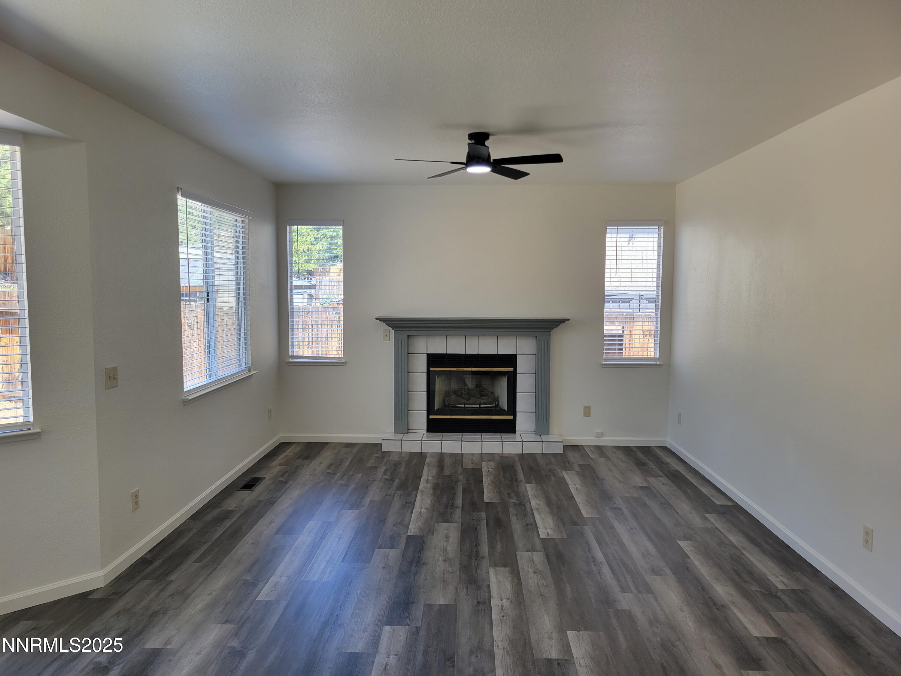 2967 Aspendale Drive Reno, NV 89503 - Photo 5 of 20 a view of an empty room with a fireplace and a window