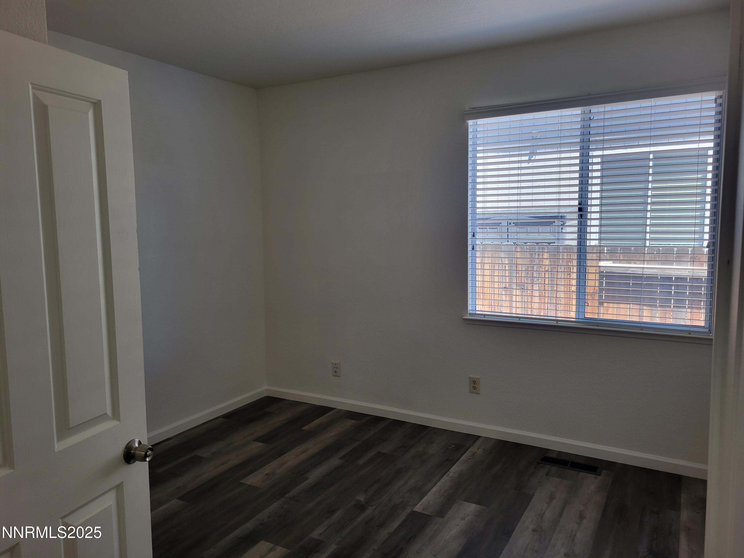 2967 Aspendale Drive Reno, NV 89503 - Photo 7 of 20 a view of an empty room with wooden floor and a window