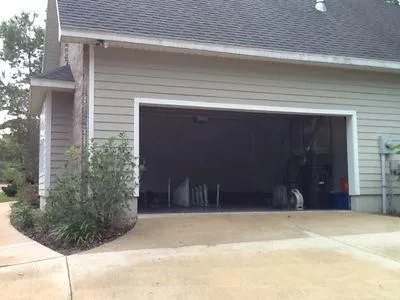 a backyard of a house with wooden deck and tree