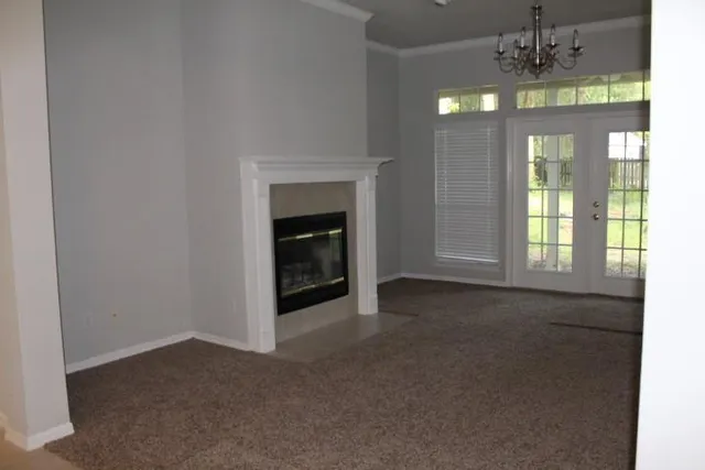 a kitchen with kitchen island granite countertop white cabinets a sink and dishwasher