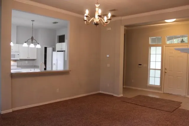 a view of empty room with floor to ceiling windows