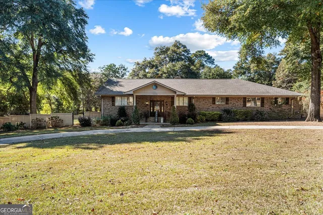 a view of a house with swimming pool and a yard