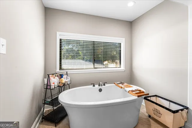 a white bath tub sitting next to a window