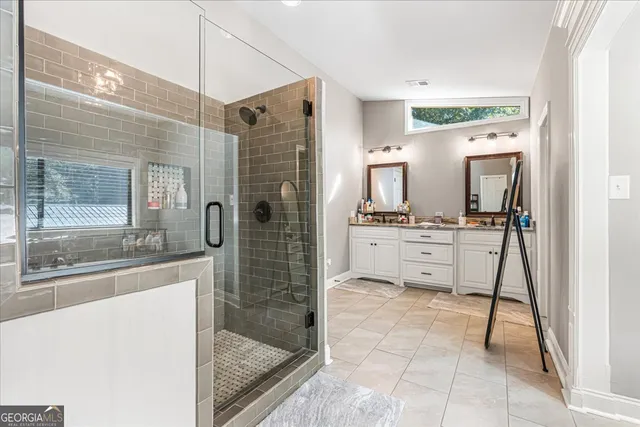 a bathroom with a sink a mirror and a shower