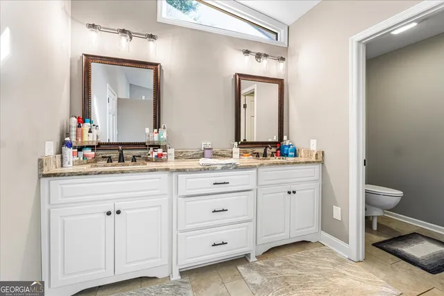 a bathroom with a granite countertop sink vanity and a mirror