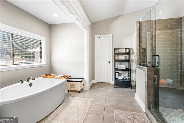 a bathroom with a bathtub and a shower