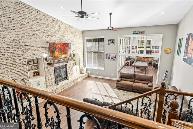 a living room with furniture and a wooden floor