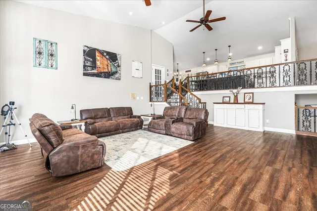 a living room with furniture large window and a fireplace