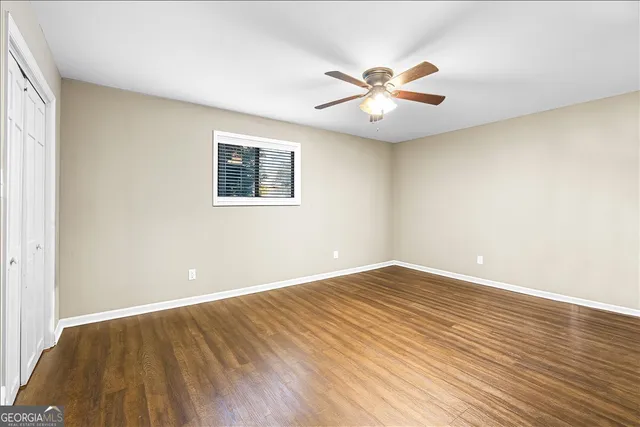 a bathroom with a granite countertop double vanity sink and a mirror
