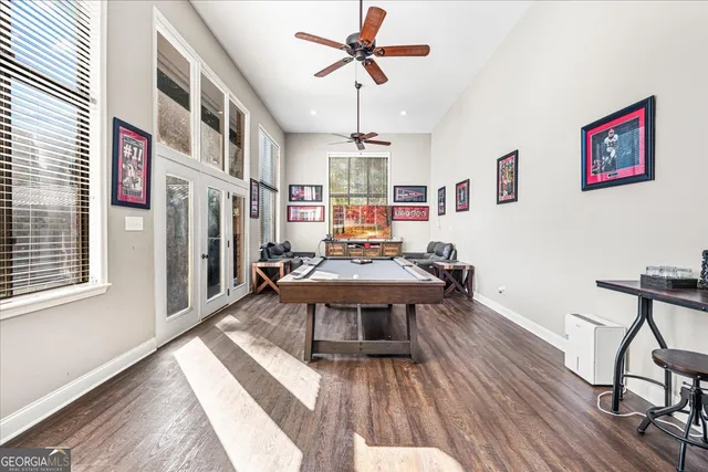 a living room with furniture pool table and a window