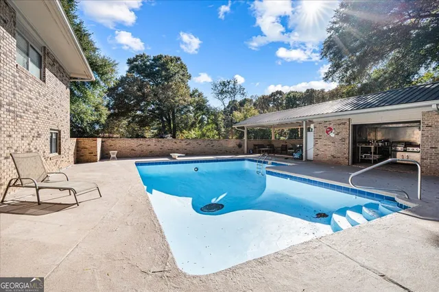 a view of an outdoor kitchen with swimming pool