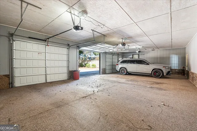 a view of a yard with plants and trees